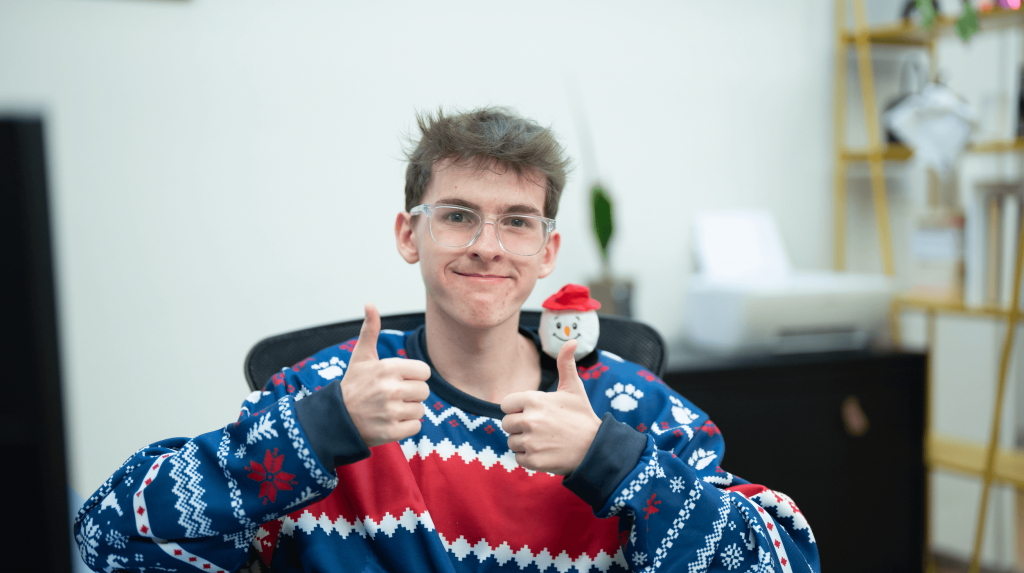An office worker celebrating in a Christmas jumper.
