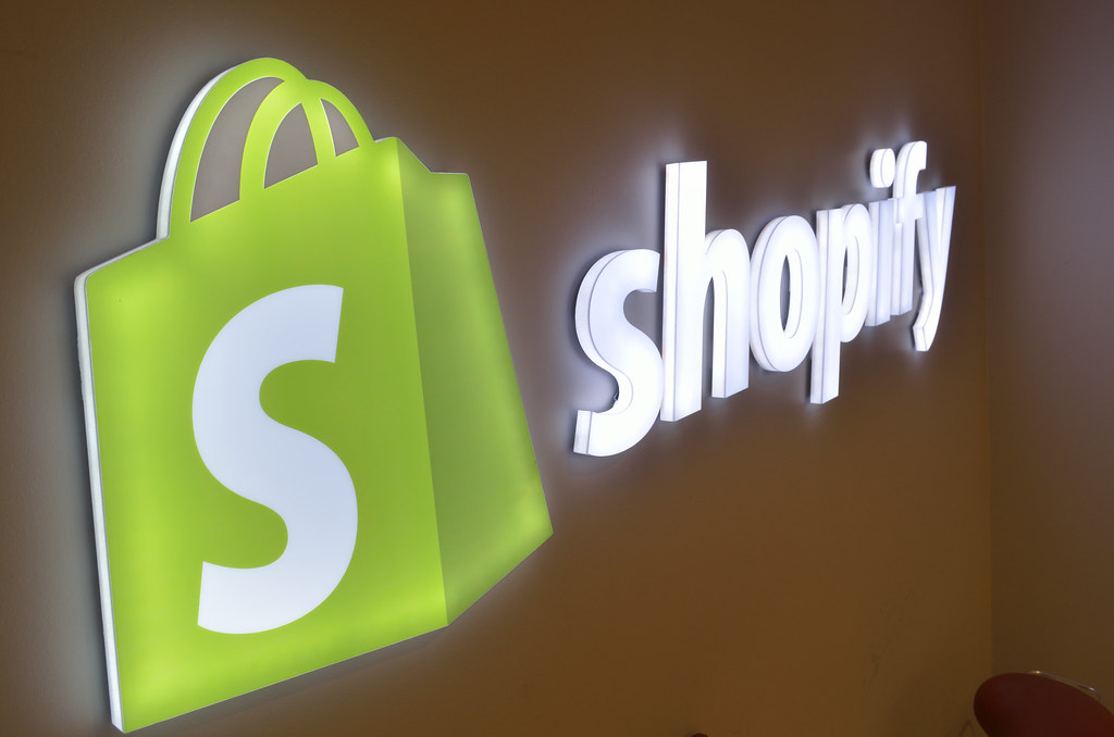 The Shopify logo on the wall as a light up sign.