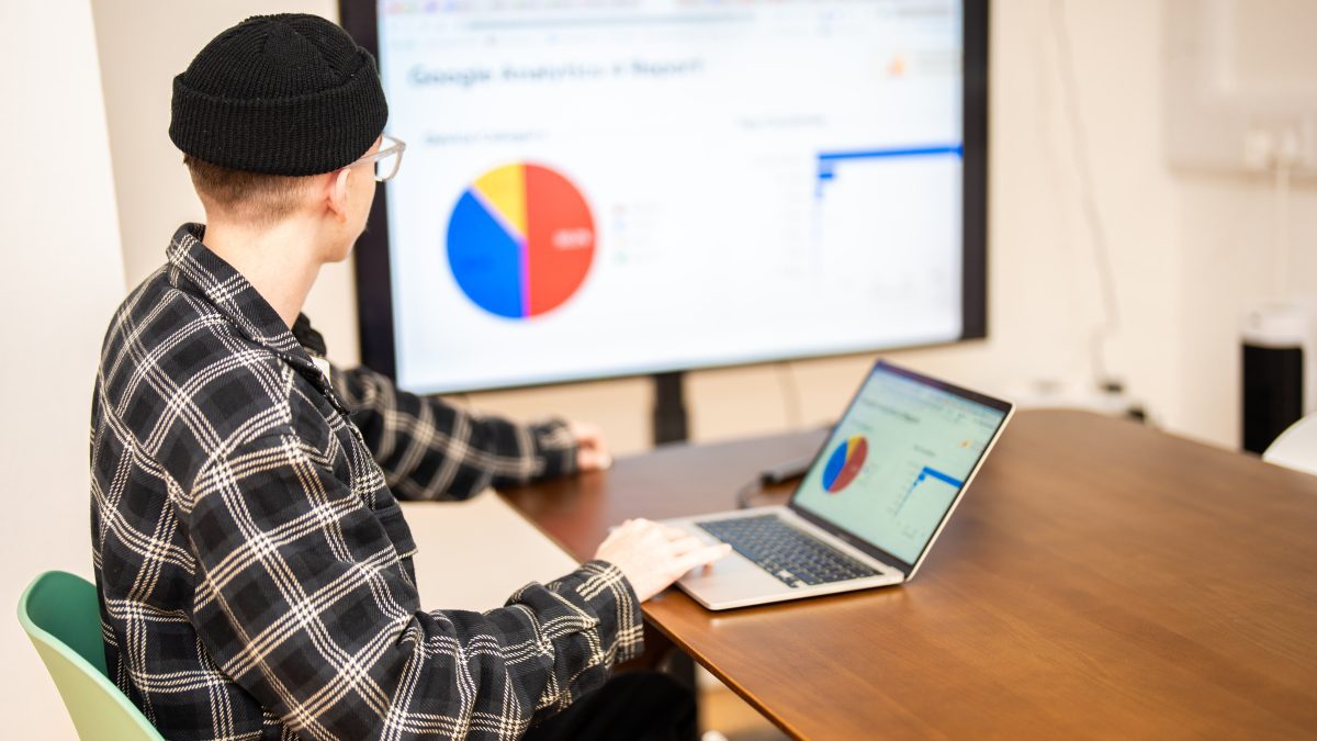 harry from the wonder agency analysing a graph of data on a tv screen