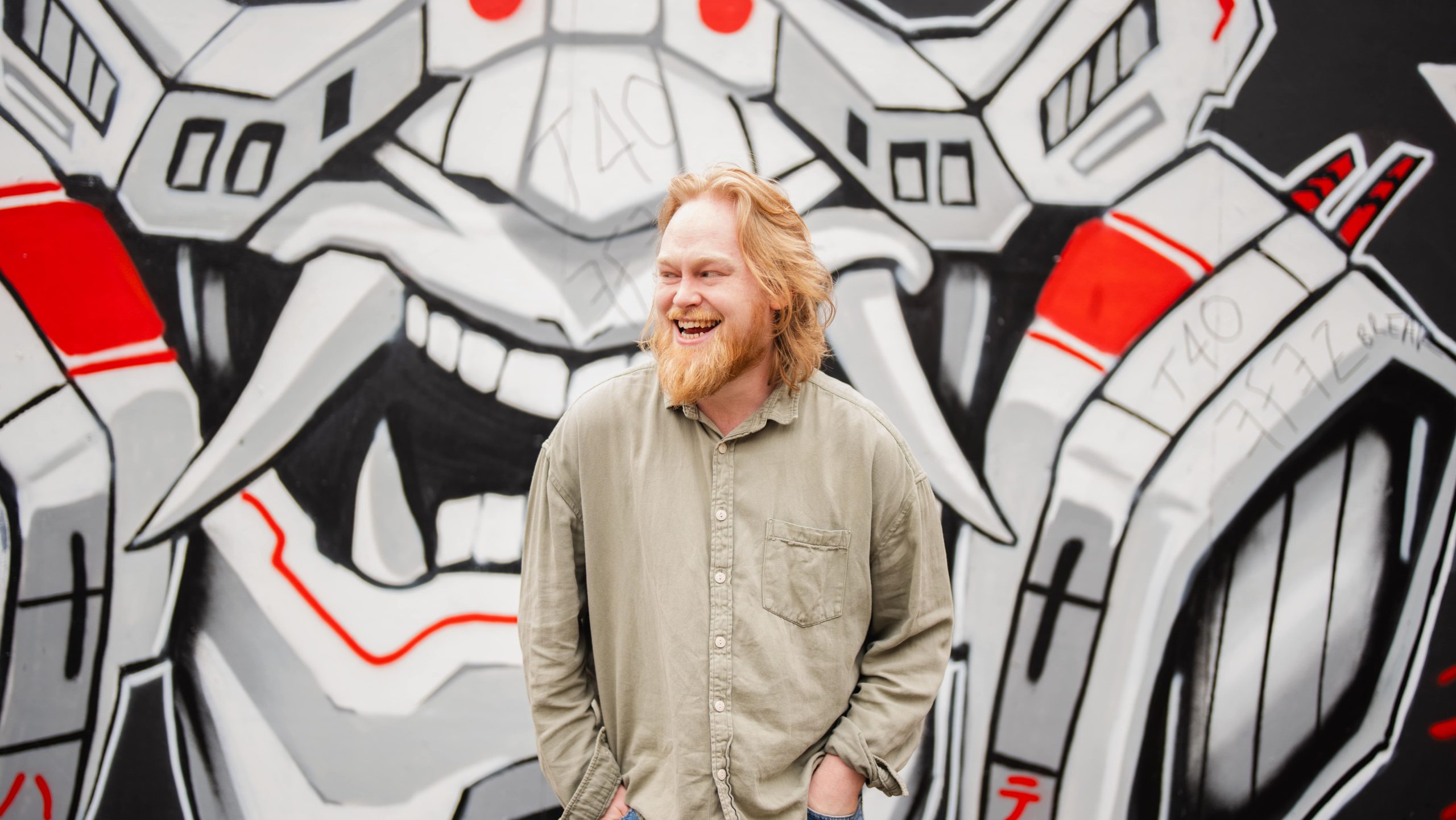 Jacob gardner-shortall, developer at the wonder agency, stood in front of graffitied wall