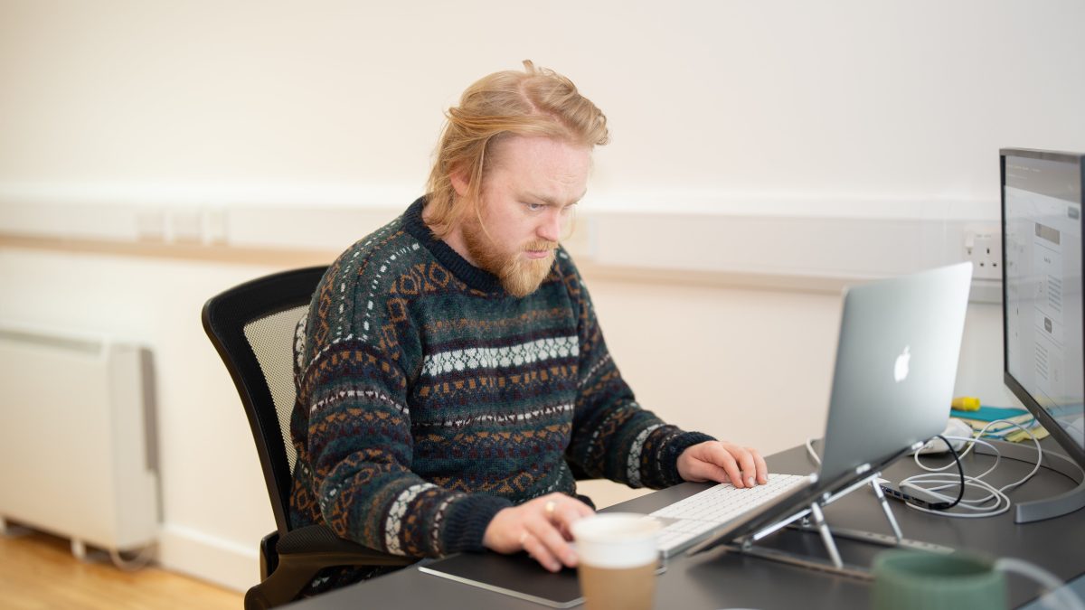 Jacob at the wonder agency coding on laptop