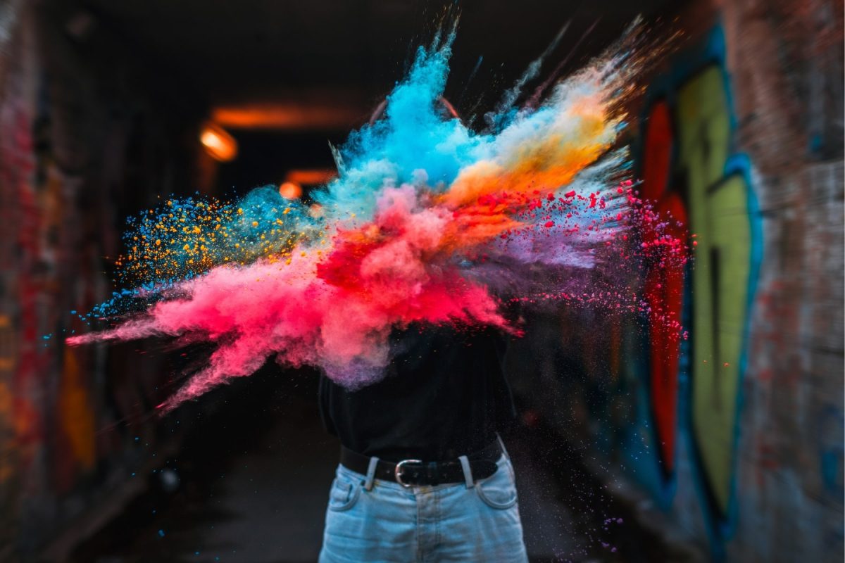 a cloud of colour powder over someones face