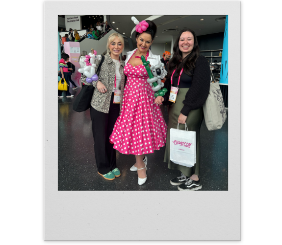 a polaroid frame showing meg and lauren from the wonder agency at atomicon event