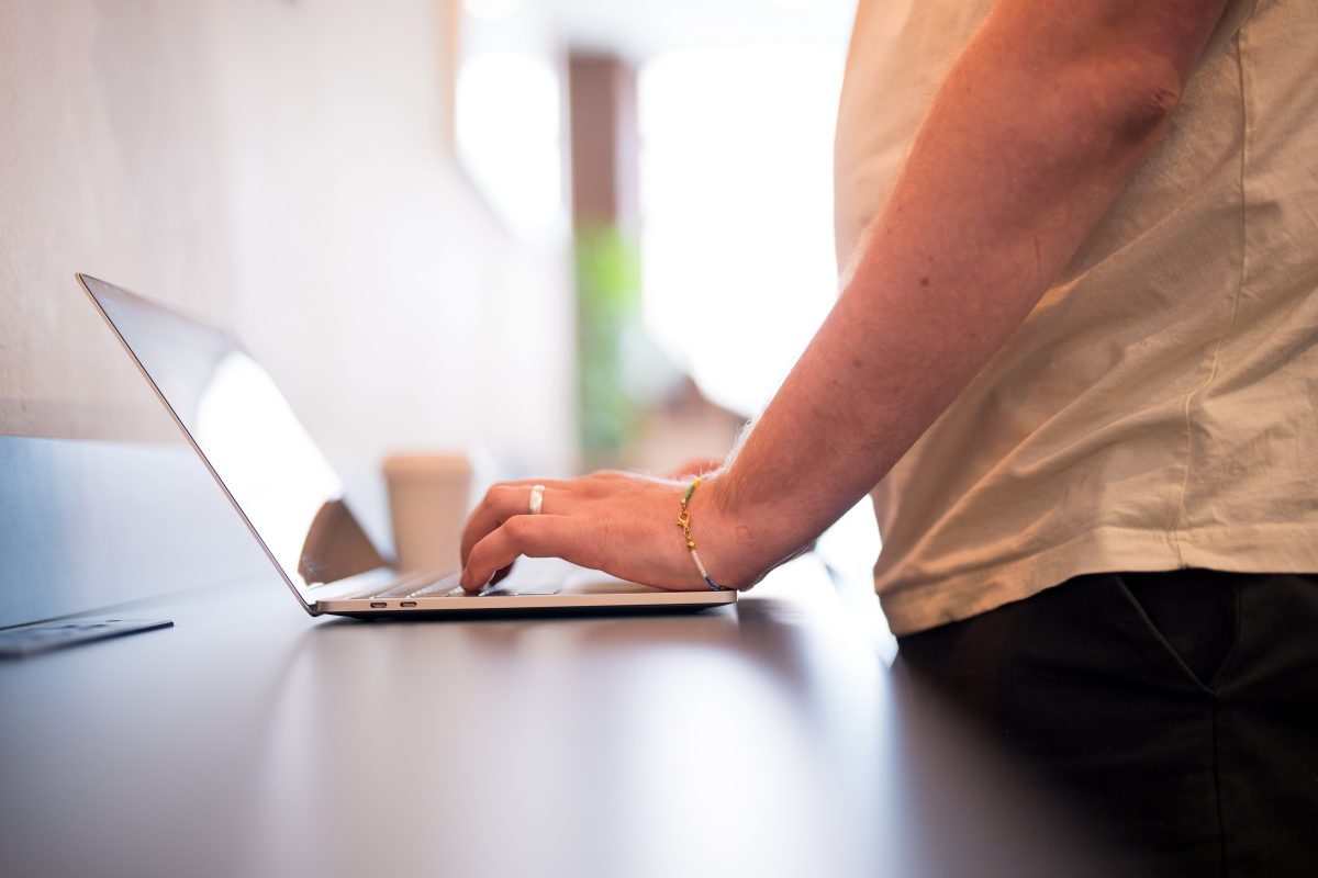 Hands coding on a laptop