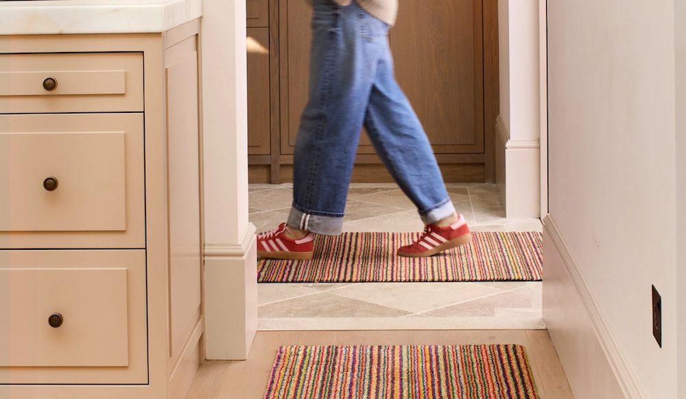 Feet walking across a hallway runner, featured on a case study on Wonder Agency's Shopify website build for Hug Rug case study