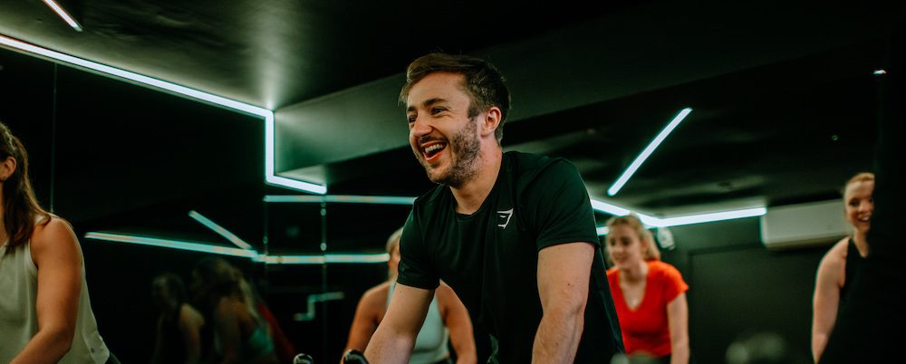 People on exercise bikes in a gym class, featured on a case study on Wonder Agency's WordPress website build for North Studio