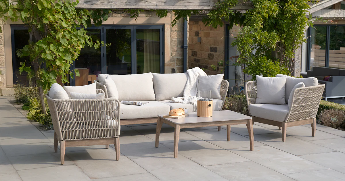 Outdoor sofa and and chairs in a garden, featured on a case study on Wonder Agency's Shopify theme upgrade for Ruma
