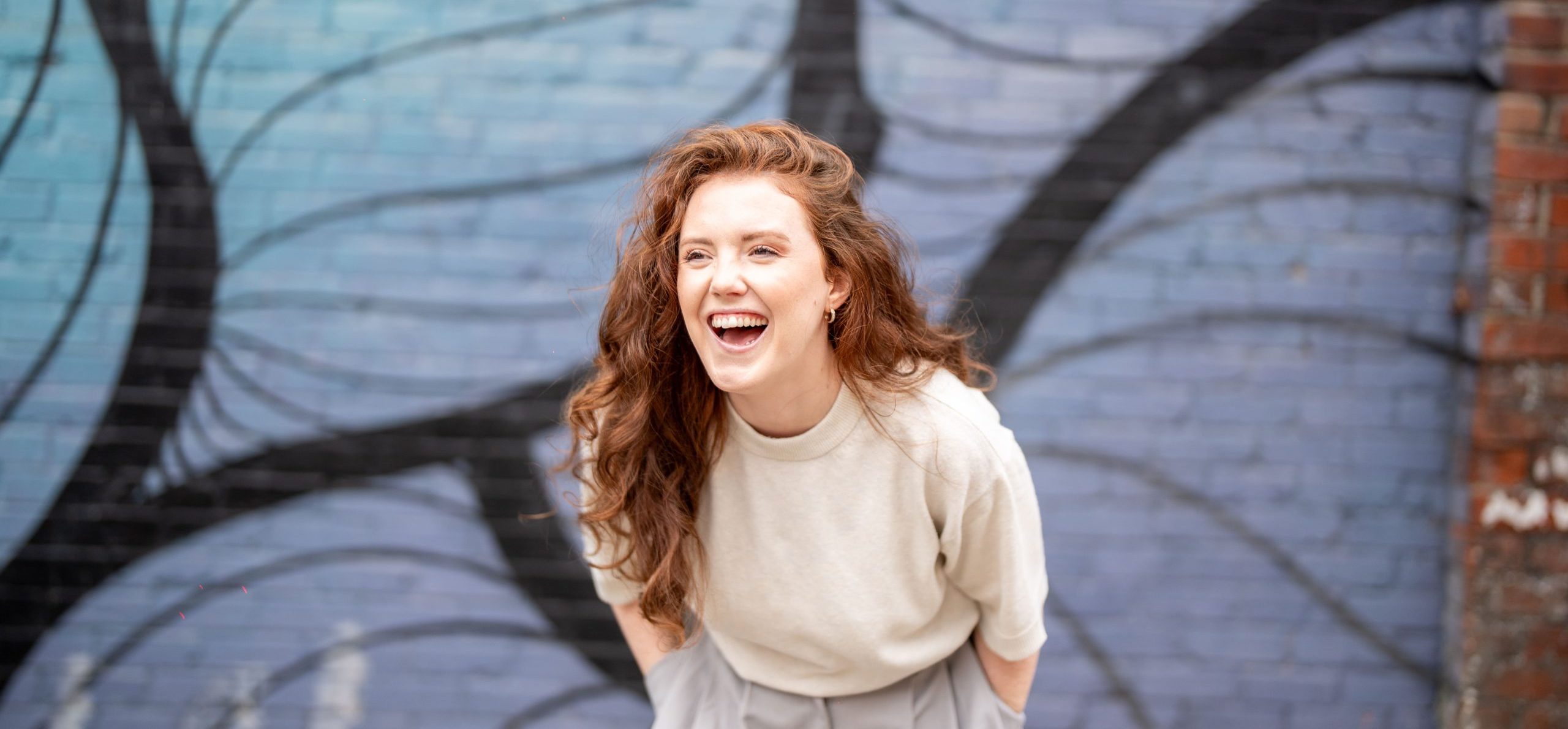 Wonder Agency team member laughing at the camera