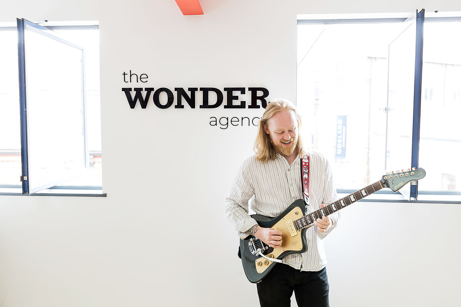 Wonder Agency team member playing the guitar in the office