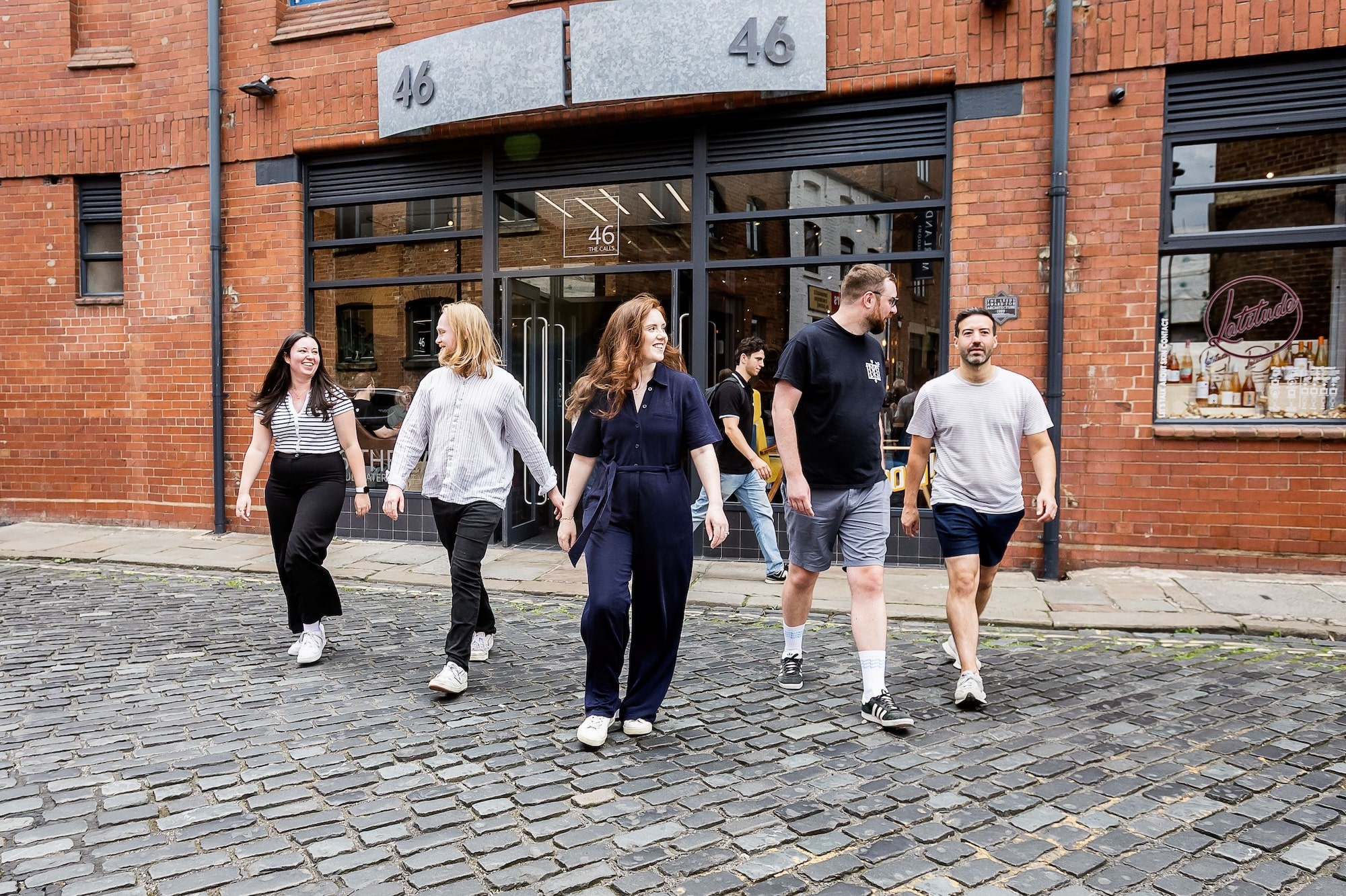 wonder agency team walking across The Calls in Leeds, experts in web development and data analytics
