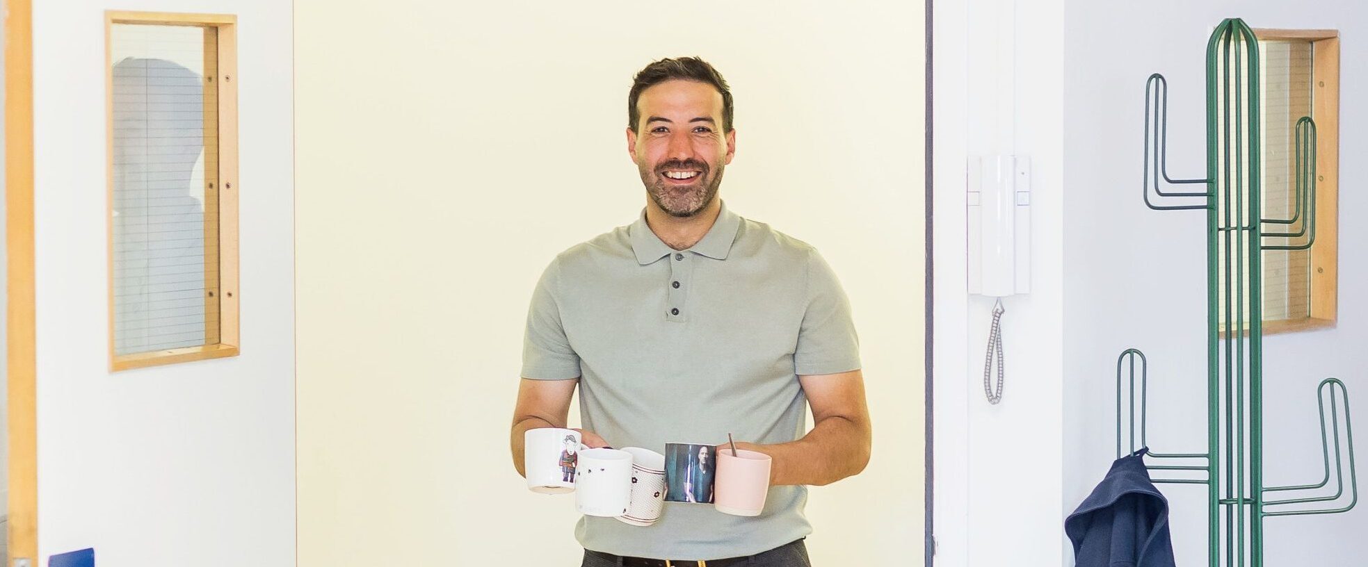 Wonder Agency team member carrying mugs during a break at the office